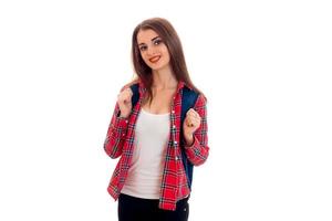 pretty stylish smart student girl with backpack on her shoulders posing and smiling on camera isolated on white background photo