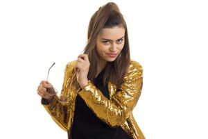 Pretty stylish brunette in golden jacket posing on camera photo
