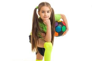 young girl with multicolor ball in hands in studio photo