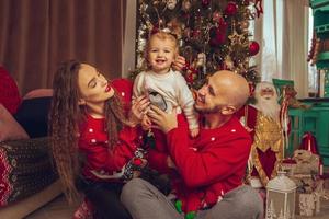 Happy family with daughter celebrate Christmas and New year together photo