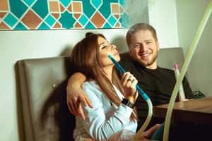 couple smokes shisha in the hookah bar photo