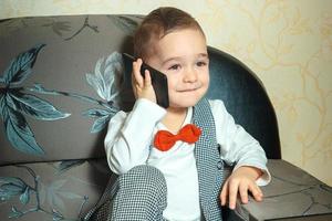 cheerful boy talking phone photo