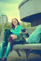 tourists resting on a bench photo