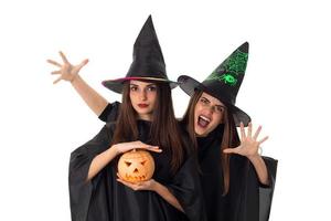 young pretty women with pumpkins in hands photo