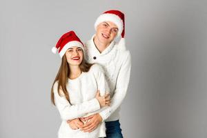 couple in love celebrates christmas in santa hat photo