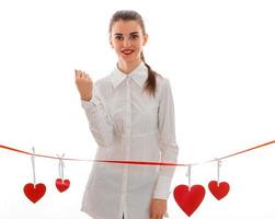 portrait of lovely brunette in love with red heart isolated on white background. saint valentine's concept. love concept. photo