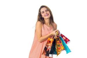 young girl laughs and holds color bright bags isolated on white background photo