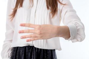 girl stretched forth a hand and four fingers shows close-up photo