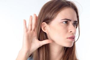 girl holds  hand with fingers next to your ear close-up photo