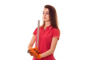 serious young girl in uniform makes renovation isolated on white background photo