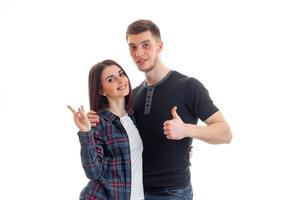 cheerful young couple standing together smiling and show hands gestures photo