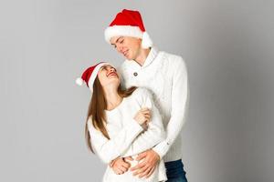 couple in love celebrates christmas in santa hat photo