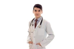 beautiful elegant doctor in uniform with stethoscope posing and looking at the camera isolated on white background photo