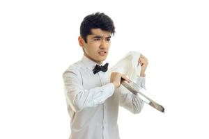 young disgruntled waiter rub towel tray for cupboards and angry photo