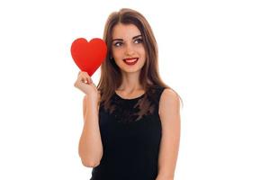 pretty young brunette girl posing with red heart isolated on white background. Saint Valentines Day concept. Love concept. photo