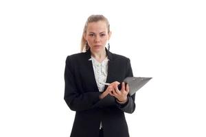 beautiful blonde busniess woman in uniform with tablet in her hands looking at the camera photo
