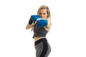 young blonde stretched forth her hands in boxing gloves photo