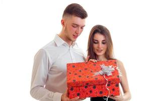 young guy and girl open gift isolated on a white background photo