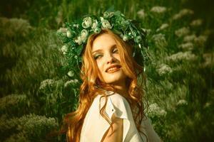 girl in the grass with wreath on head photo