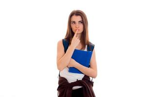 young serious student girl with blue folders for notebooks in hands posing isolated on white background in studio photo