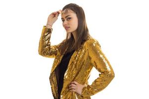 young glamorous Lady poses in the Studio in the Golden jacket photo