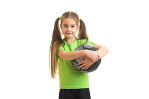 a charming little girl with giant holds the ball photo