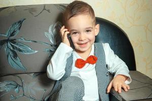 young boy in suit and bowtie photo