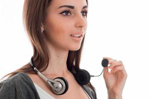 beautiful young call center office girl with headphones and microphone posing isolated on white background photo