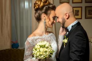 young just merried couple in love hugging and smiling to each others photo