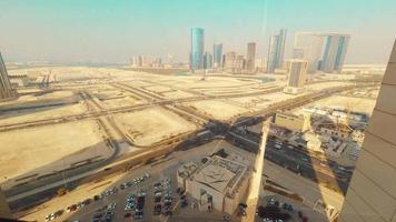 Panoramic window view to high buildings in deserted city Sharjah district. Rented apartment stunning views and real estate business in united arab emirates video