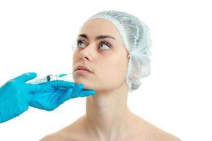 Portrait of a young girl in the medical CAP which the beautician enters the vaccine close-up photo