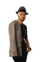 glamour young unshaved man in hat and jacket looking at the camera photo