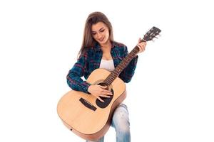 lovely girl with guitar in hands photo