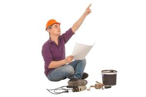 worker with plan in his hands and tools around photo