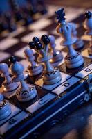 Chess board with chess pieces on blue background. Concept of business ideas and competition and strategy ideas. White king and queen close up. photo