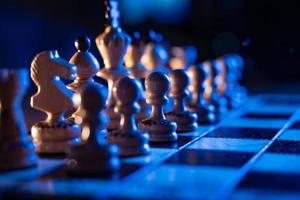 Chess board with chess pieces on blue background. Concept of business ideas and competition and strategy ideas