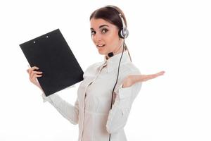 Retrato de una joven y encantadora mujer del centro de llamadas con auriculares y micrófono aislado de fondo blanco foto