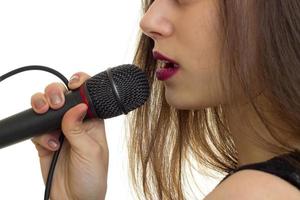 close-up portrait of a young girl with a microphone and red lipstick photo