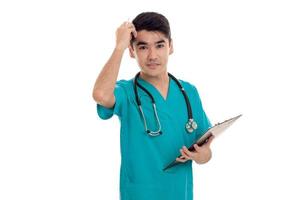 studio portrait of pretty male doctor in uniform posing isolated on white background photo