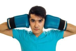 sports man posing in blue boxing gloves in studio isolated on white background photo