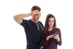 man surprised looking female pictures in her phone photo