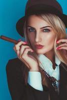 Portrait of sensual woman in hat with cigar photo