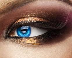 Macro photo of blue woman eye. looking away. with professional make up