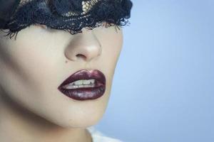 charming young lady with black lace on eyes and beautiful lips photo