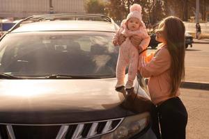 Cute young mother with her little baby girl photo