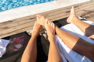 feet of couples on the beach photo