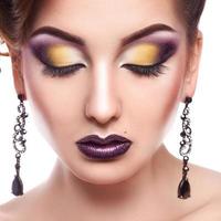 Portrait of pretty female with closed eyes and multicolored make up photo