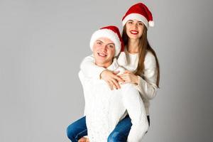 couple in love celebrates christmas in santa hat photo