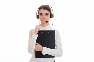 a young girl stands upright holding a Tablet and listening headset photo