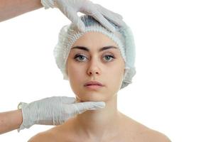 a young girl with a special medical hair cap at doctor-cosmetologist photo